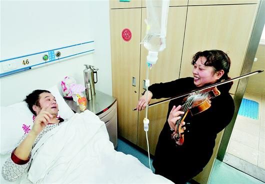 陈惠芳在病房为袁春生拉琴